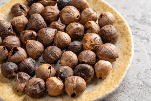 Fermented black garlic. The color is a result of the Maillard reaction or caramelization. Black garlic can help to regulate blood sugar levels photo