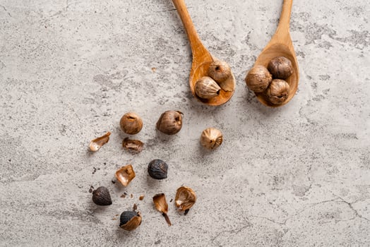 Fermented black garlic. The color is a result of the Maillard reaction or caramelization. Black garlic can help to regulate blood sugar levels photo