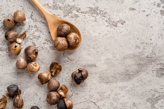 Fermented black garlic. The color is a result of the Maillard reaction or caramelization. Black garlic can help to regulate blood sugar levels photo