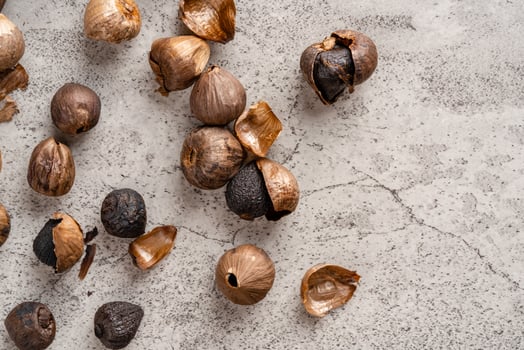 Fermented black garlic. The color is a result of the Maillard reaction or caramelization. Black garlic can help to regulate blood sugar levels photo