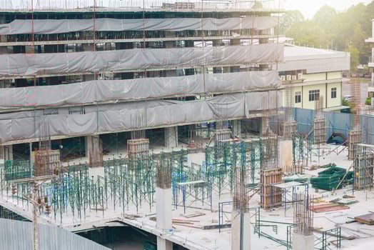 Tower cranes at construction site on sky background. Multi Storey Residential Buildings construction. Tower crane on Housing renovation. tower crane is attached to boom load secured with steel cables. photo