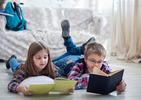 Children readind book in living room photo