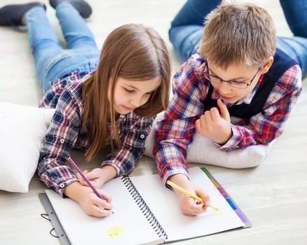 Two little kids drawing with crayons photo