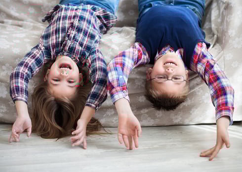 Happy children upside down on the sofa photo