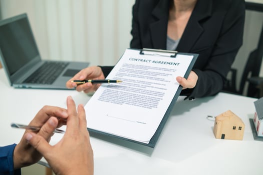 Real estate agent is talking to customer to present promotion for signing contract buy and selling real estate in company project in real estate office. present promotion to make customer decide buy. photo