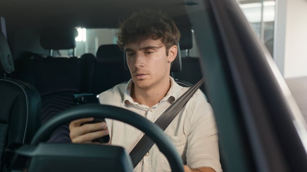 Caucasian confused sad driver upset puzzled male businessman frustrated man stressed business employer in car auto automobile parking lot traffic jam gadget addict lost problem bad news mobile phone photo