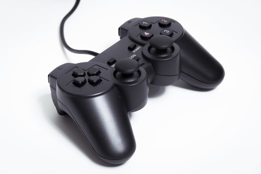 Black controller on white background, game device, Joystick on a white background. photo