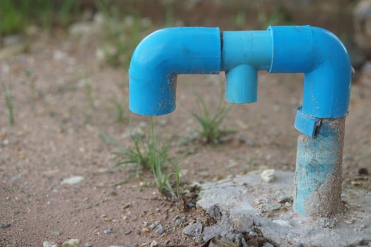 Blue PVC pipe installed on ground, used as a pipe to drain gas from toilets in houses or buildings. Gas disposal pipe. Concept, wisdom to do toilet system in local house. photo