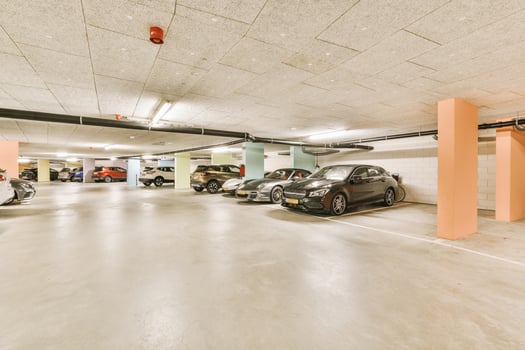 A parking garage with several cars parked in it photo