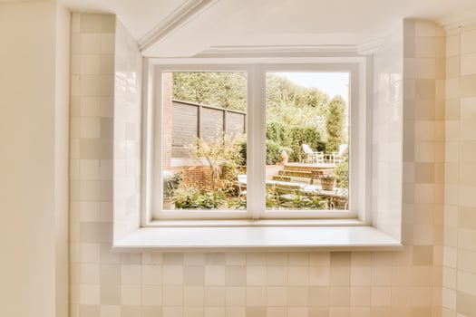 A bathroom with a window and a tub photo