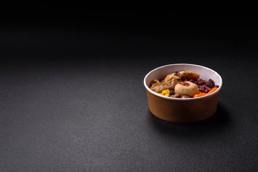 A colorful vegetarian dish consists of fish, beans, corn, mushrooms photo