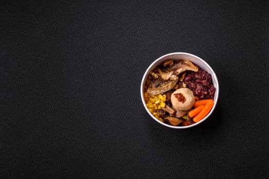 A colorful vegetarian dish consists of fish, beans, corn, mushrooms photo