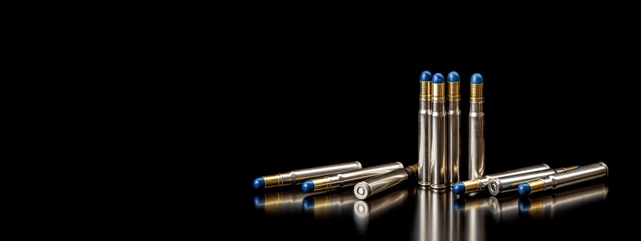 Bullet isolated on black background with reflexion. Rifle bullets close-up on black back. Cartridges for rifle and carbine on a black. photo