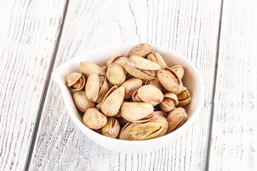 Salted tasty pistachio nuts heap photo