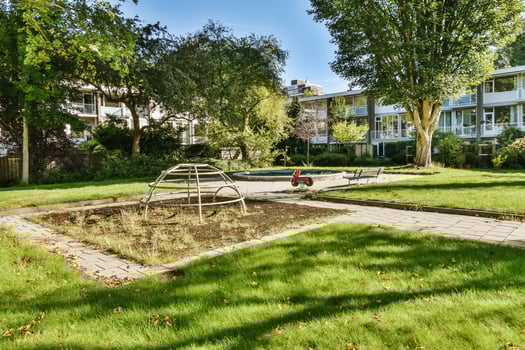 An apartment complex with a playground in the yard photo