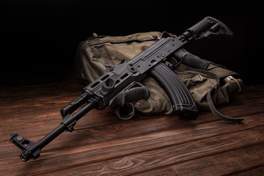 Soviet carbine in modern body kit. Weapons of Russia and the Soviet Union. Classic Soviet AK machine gun on a wooden back photo