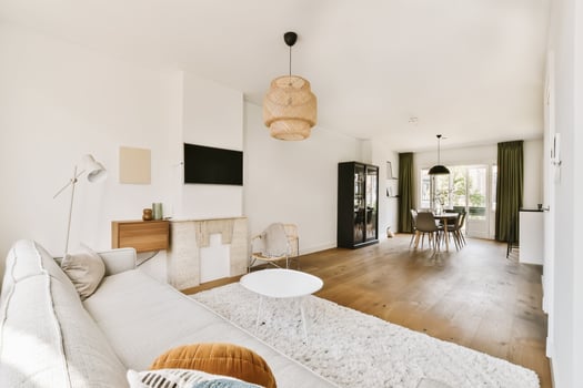 A living room with a couch, table and chairs photo