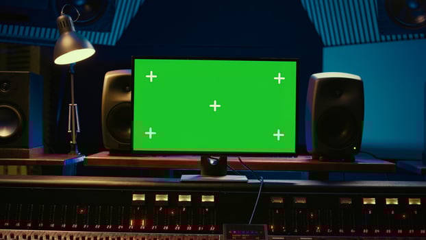Empty professional recording studio control room with greenscreen on display, editing and processing tracks. Motorized faders, buttons and sliders operated for mix and master techniques. Camera B. photo