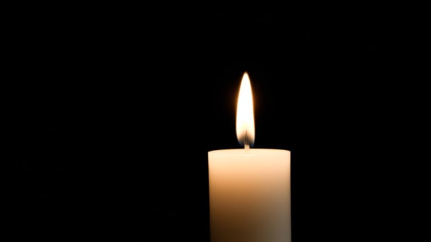 Single Candle Flame in Darkness photo