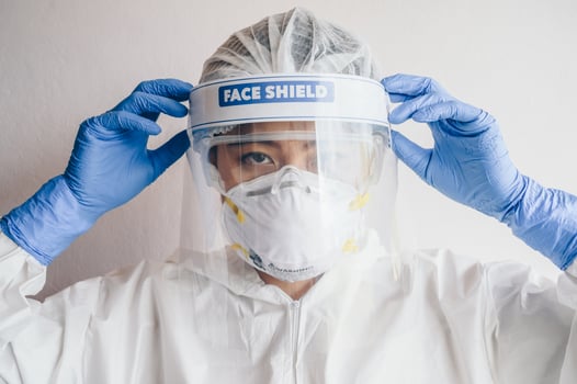 Healthcare worker wearing PPE suit for working in hospital during Covid-19 pandemic outbreak. PPE is equipment that will protect the user against health or safety risks at work. photo