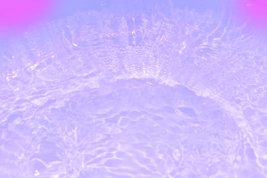 Bluewater waves on the surface ripples blurred. Defocus blurred transparent blue colored clear calm water surface texture with splash and bubbles. Water waves with shining pattern texture background. photo