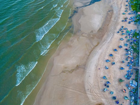 Relaxing aerial beach scene, summer vacation holiday template banner. Waves surf with amazing blue ocean lagoon, sea shore, coastline. Perfect aerial drone top view. Peaceful bright beach, seaside photo