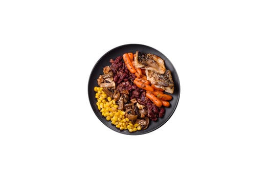 A colorful vegetarian dish consists of fish, beans, corn, mushrooms photo