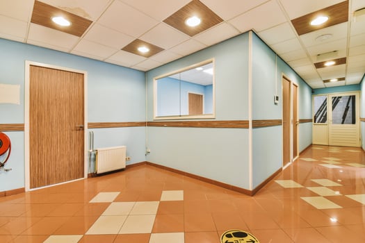 A hallway with a door and a fire hose photo