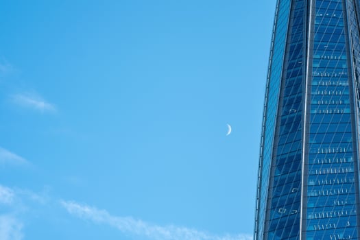 modern architecture, glass facade element of skyscraper against evening sky photo