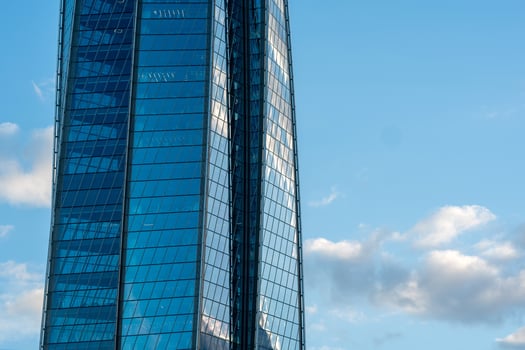 modern architecture, glass facade element of skyscraper against evening sky photo