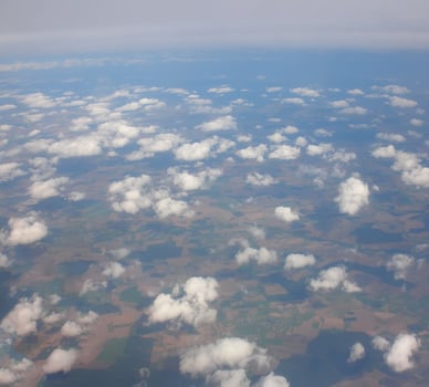 View from airplane window. White clouds above the land. photo