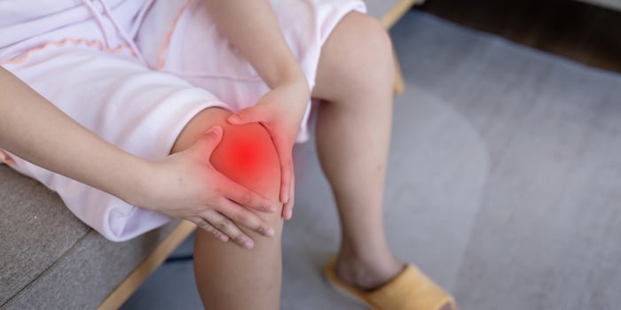 Woman Experiencing Knee Pain at Home. Understanding Joint Discomfort photo