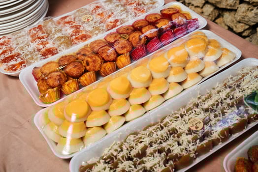 a table with many trays of food on it photo