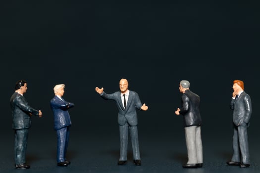Miniature people Businessman standing on black background , Concept of Business leader and teamwork photo