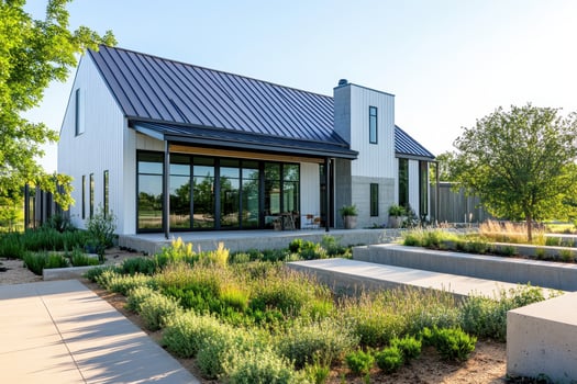 Modern house with a sleek design surrounded by greenery and landscaped areas photo