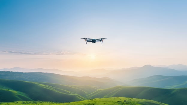 A drone flying over a green valley with mountains in the background photo