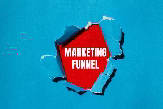 Marketing funnel message written on ripped torn blue paper with red background. Conceptual marketing funnel symbol. Copy space. photo