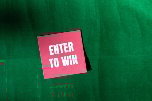 Enter to win message written on pink paper with green background. Conceptual enter to win symbol. Copy space. photo