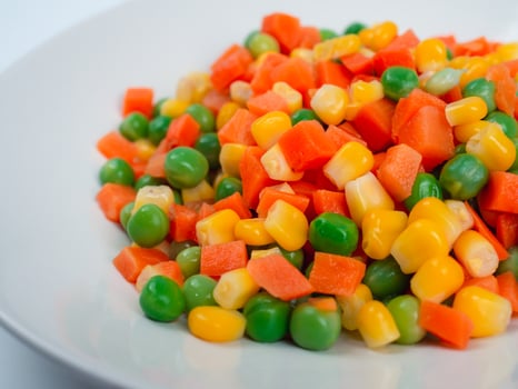 Organic Food. Mixed Vegetables Isolated White Background. Vegetable containing carrots, peas, and corn on white background, Healthy food, Colorful mixed vegetables. photo