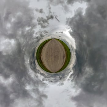 simple little tiny planet without buildings in blue sky with beautiful clouds. Transformation of spherical panorama 360 degrees. Spherical abstract aerial view. Curvature of space. photo