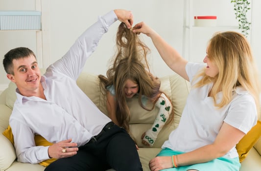 Family sitting on sofa in their living room. Daughter have injury hand but she is happy be together her family. photo
