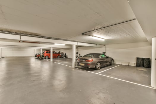 An empty parking garage with two cars parked in it photo