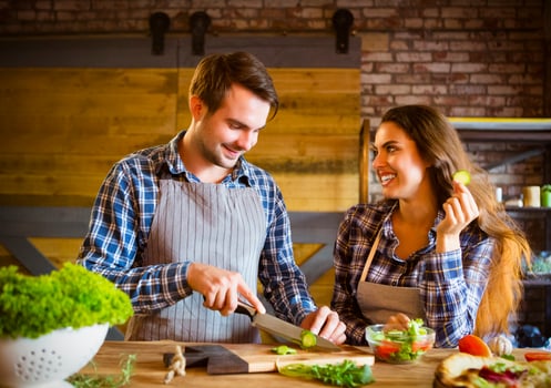 Young smiling couple cooking together photo