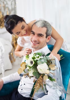 Cheerful married couple in white room photo