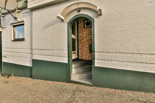 A white building with a green door photo