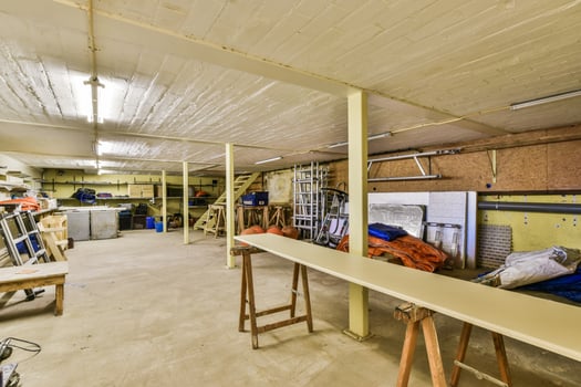 A garage with a table and a ladder photo