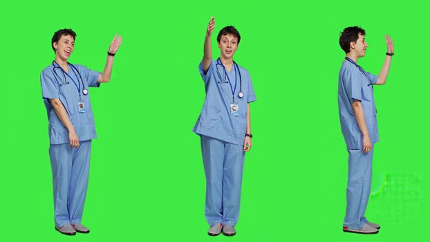 Woman nurse waving hello and inviting people to come closer, calling over patients for checkup examinations against greenscreen. Medical assistant greeting persons and asking them to come. Camera A. photo
