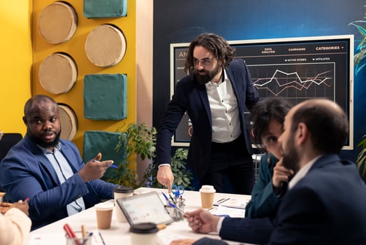 Business colleagues evaluating performance and success metrics within the organization, presenting project details. Coworkers measuring infographics and reports, team efficiency and progress. photo