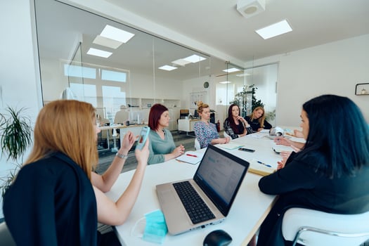 Diverse Business Team Discussing Projects in a Modern Glass Office. photo