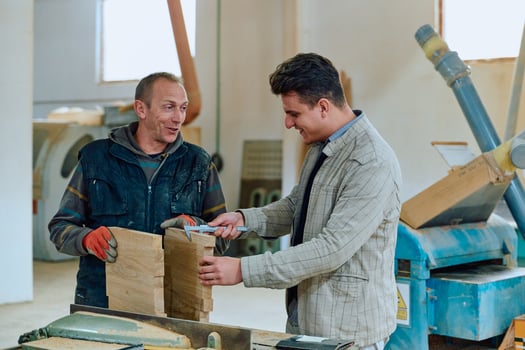 Production Manager Demonstrating Woodcraft Techniques to Employee for Decorative and Residential Items photo